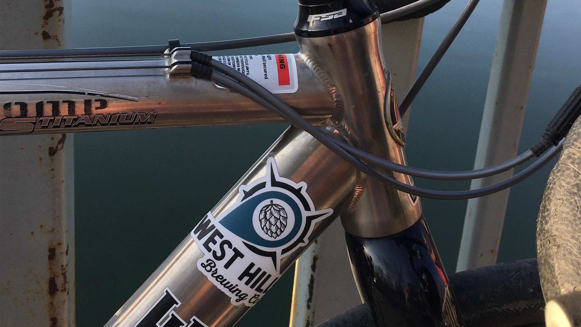 Closeup of a bicycle with a West Hill Brewing Company sticker
